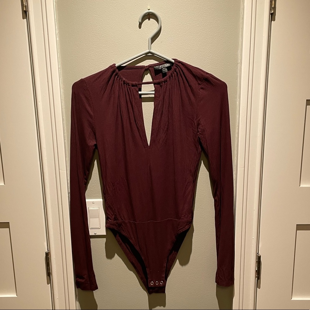 Burgundy bodysuit.